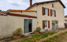 Two renovated stone town houses with outbuildings and garden